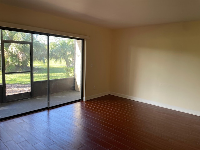 spare room with dark hardwood / wood-style floors