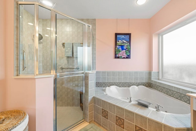 bathroom with independent shower and bath and tile patterned flooring