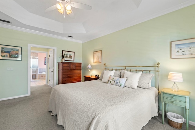 carpeted bedroom with crown molding, ceiling fan, connected bathroom, and a raised ceiling