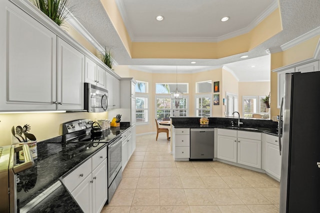 kitchen with sink, white cabinetry, crown molding, light tile patterned floors, and appliances with stainless steel finishes