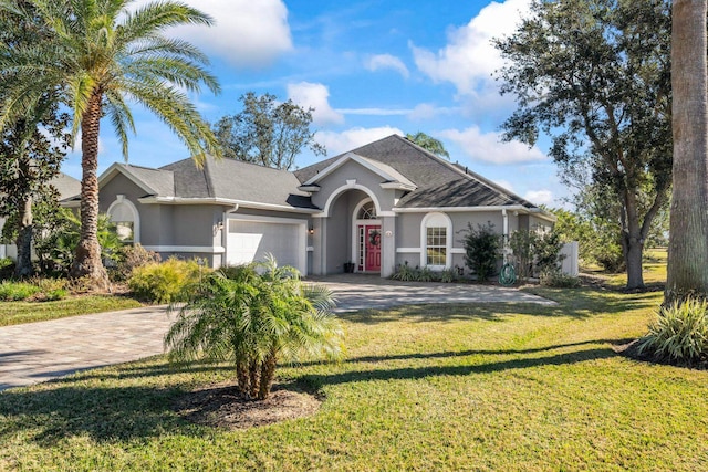 single story home featuring a garage and a front yard