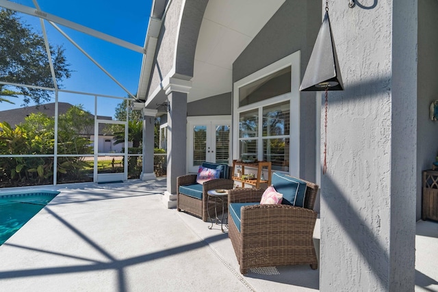 view of patio / terrace featuring french doors, an outdoor living space, and a lanai