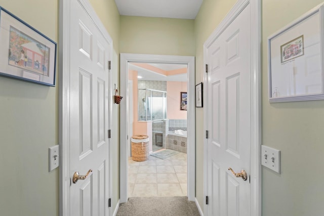 hall with light tile patterned floors