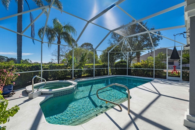 view of pool featuring a lanai, a patio, and an in ground hot tub