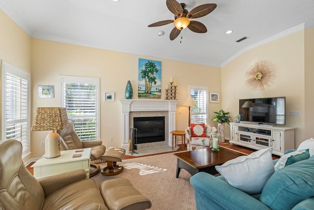 living room featuring a fireplace, lofted ceiling, ornamental molding, ceiling fan, and a textured ceiling