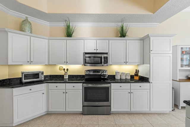 kitchen featuring white cabinetry, stainless steel appliances, and a textured ceiling