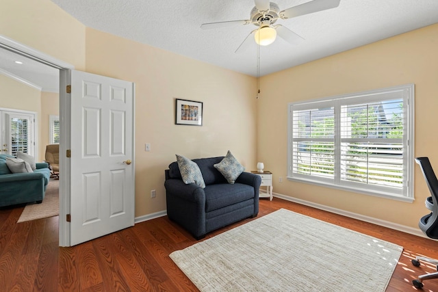 interior space featuring ceiling fan, dark hardwood / wood-style flooring, and a textured ceiling