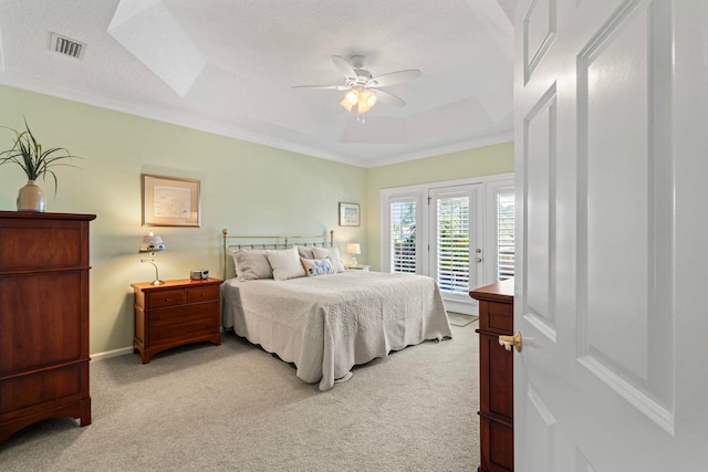 bedroom with ceiling fan, access to exterior, ornamental molding, light carpet, and a raised ceiling