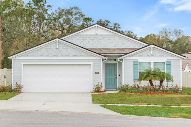 view of front of home featuring a front lawn and a garage