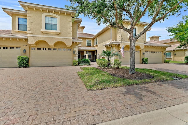175 Laterra Links Cir Unit 101, Saint Augustine, FL 32092 - view of front of home featuring stucco siding, driveway, and a garage