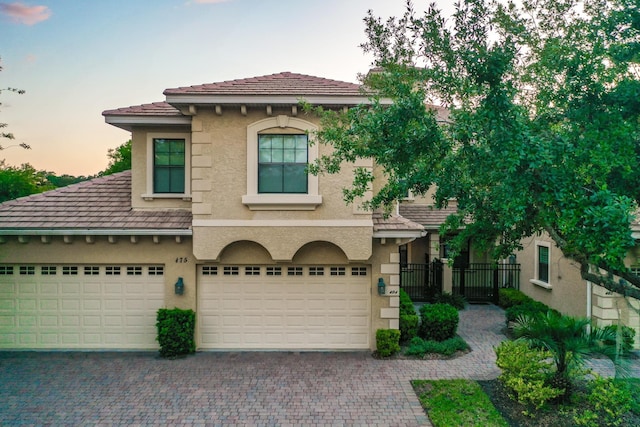 175 Laterra Links Cir Unit 101, Saint Augustine, FL 32092 - mediterranean / spanish-style home with fence, driveway, a garage, stucco siding, and a tiled roof