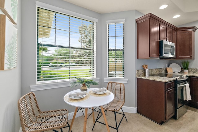 175 Laterra Links Cir Unit 101, Saint Augustine, FL 32092 - kitchen featuring stainless steel appliances, baseboards, light stone counters, and recessed lighting