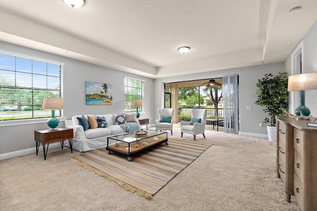 175 Laterra Links Cir Unit 101, Saint Augustine, FL 32092 - living room with baseboards, a tray ceiling, and carpet floors