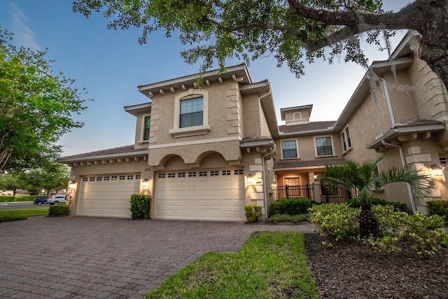 175 Laterra Links Cir Unit 101, Saint Augustine, FL 32092 - view of front of home with stucco siding, a garage, fence, and decorative driveway