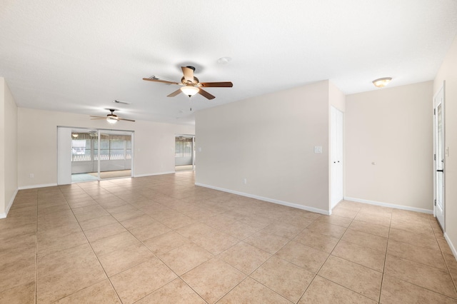 tiled spare room featuring a textured ceiling and ceiling fan