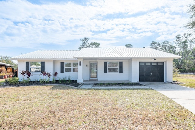 single story home with a garage and a front yard