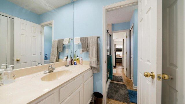 bathroom with tile patterned flooring, connected bathroom, and vanity