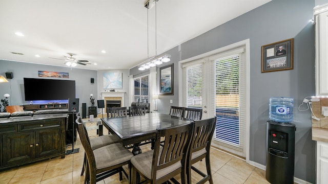 dining space featuring light tile patterned floors, a fireplace, recessed lighting, and ceiling fan