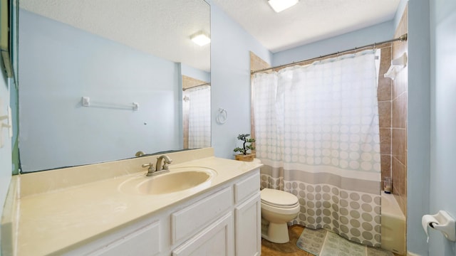 bathroom featuring vanity, toilet, shower / bath combo, and a textured ceiling