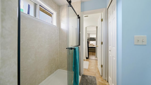 bathroom with tile patterned floors and a shower stall