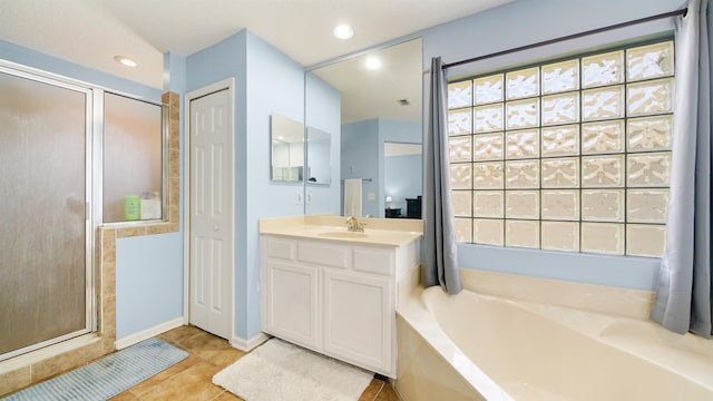 full bath with a garden tub, recessed lighting, a shower stall, tile patterned flooring, and vanity