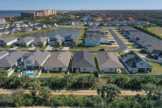 birds eye view of property with a water view and a residential view