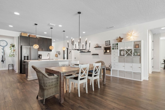 dining area featuring recessed lighting, dark wood-style flooring, a textured ceiling, and baseboards