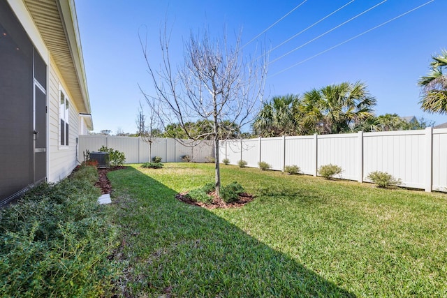 view of yard featuring a fenced backyard and central AC