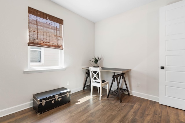 office space with wood finished floors and baseboards