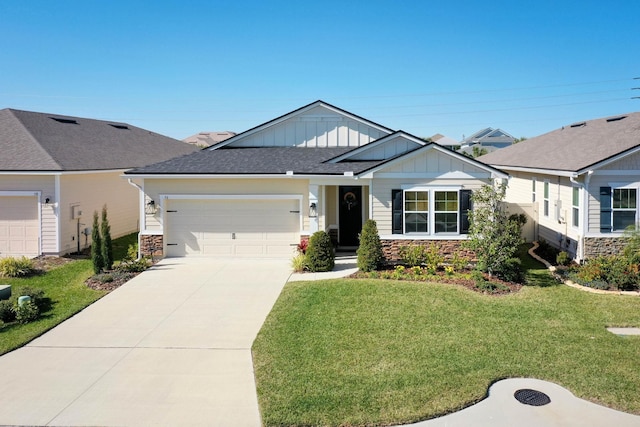 view of front of property featuring board and batten siding, a front yard, stone siding, and concrete driveway