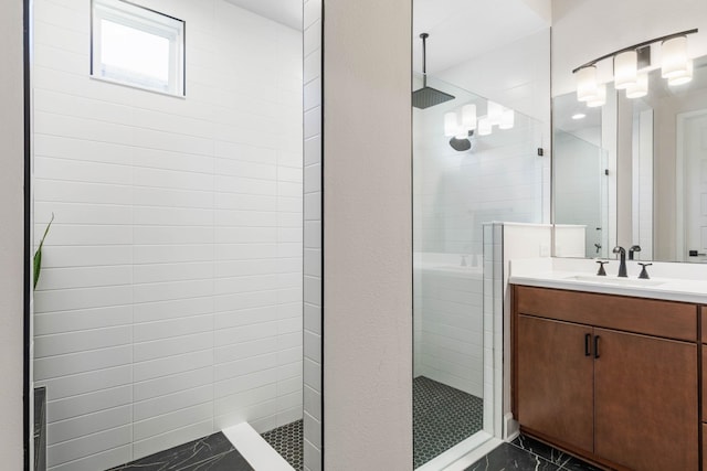 bathroom with walk in shower and vanity