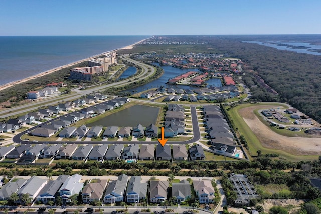 drone / aerial view with a water view and a residential view