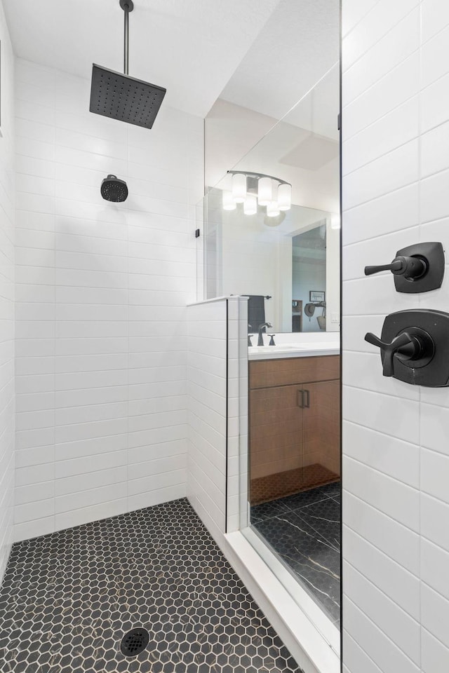 bathroom with a walk in shower and vanity