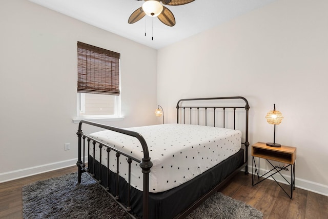 bedroom featuring a ceiling fan, baseboards, and wood finished floors