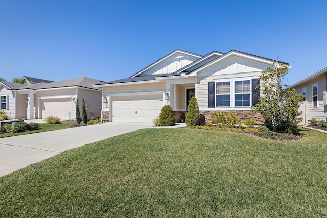 view of front of property featuring a garage, concrete driveway, stone siding, a front lawn, and board and batten siding