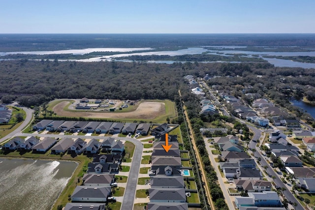 drone / aerial view featuring a residential view and a water view