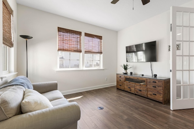 living area with ceiling fan, dark wood finished floors, and baseboards