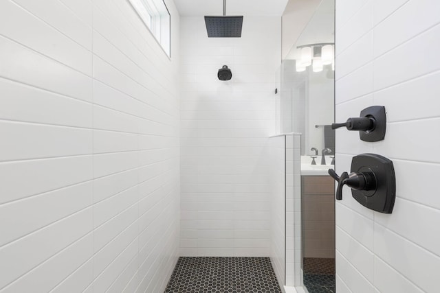 full bath with a tile shower