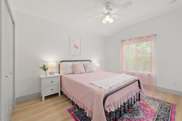 bedroom featuring ceiling fan, a closet, and light wood-type flooring