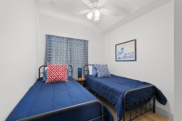 bedroom with hardwood / wood-style flooring, ceiling fan, and lofted ceiling