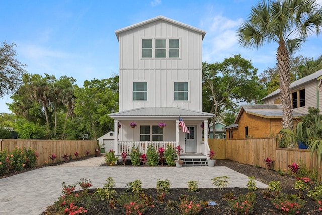 view of front of house with an outbuilding, a porch, and a garage