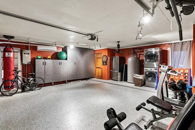 garage with a wall unit AC, stainless steel fridge, stacked washing maching and dryer, and a garage door opener