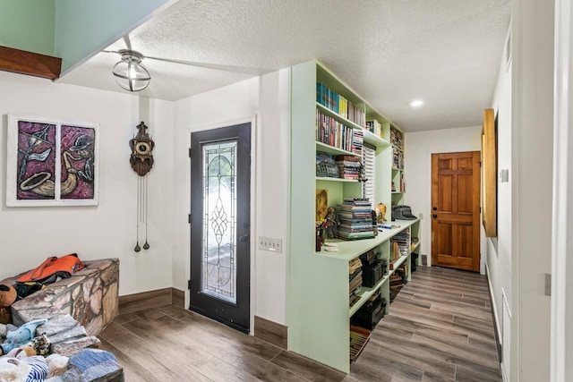 foyer entrance featuring hardwood / wood-style floors and a textured ceiling