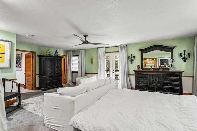 bedroom with access to exterior, french doors, a textured ceiling, and ceiling fan