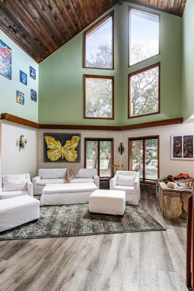 living room featuring a wealth of natural light, hardwood / wood-style floors, high vaulted ceiling, and wood ceiling