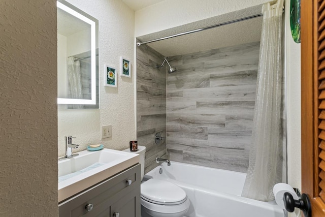 full bathroom featuring vanity, toilet, shower / bath combo with shower curtain, and a textured ceiling