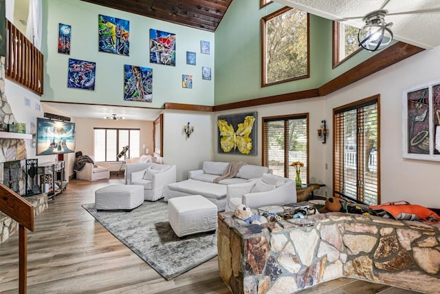 living room with ceiling fan, high vaulted ceiling, and hardwood / wood-style flooring