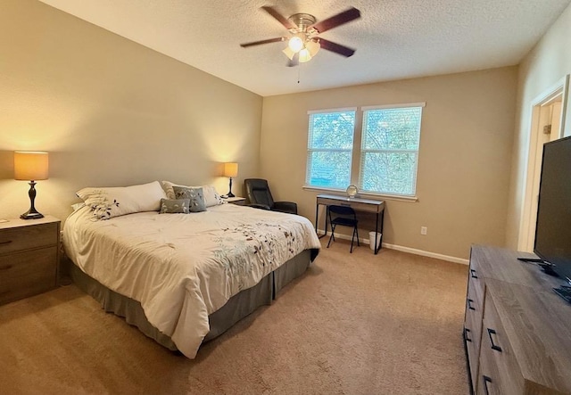 bedroom featuring light carpet, a textured ceiling, baseboards, and a ceiling fan
