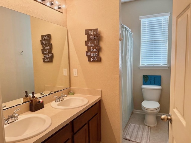 full bathroom with toilet, double vanity, and tile patterned flooring