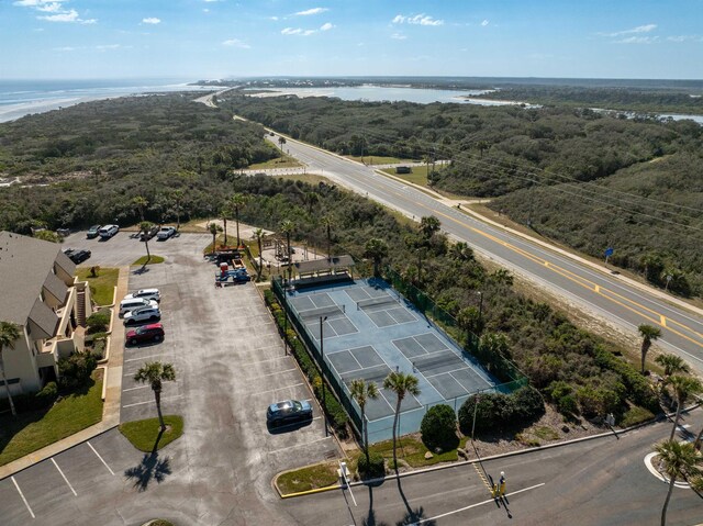 aerial view with a water view and a forest view